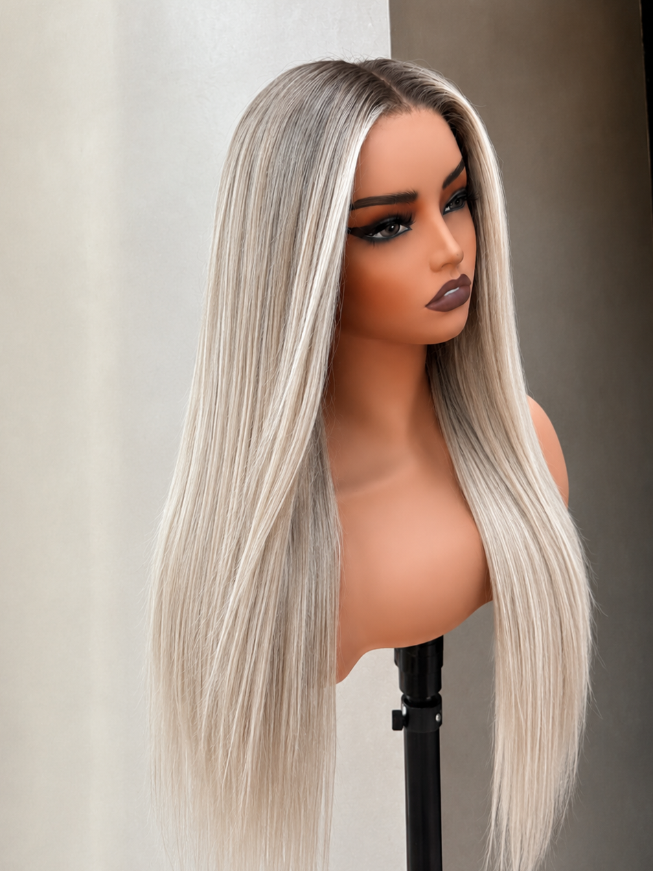 Long straight wig with a silver-gray and ash blonde ombre color, displayed on a mannequin head stand against a neutral background.